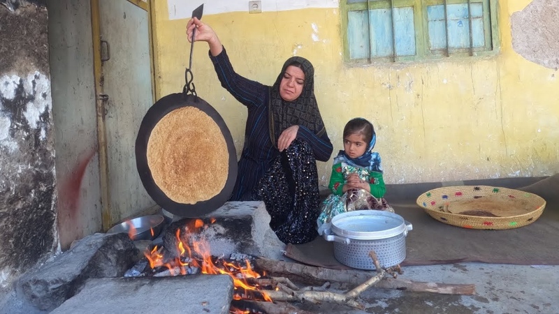 Cooking local bread by a village woman for breakfast in Iran